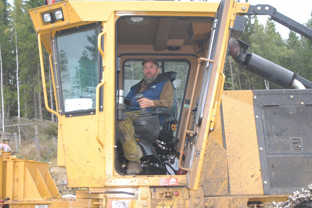 Kurt Collin sits inside the cab of a Mackolines Machines & Hire skidder.