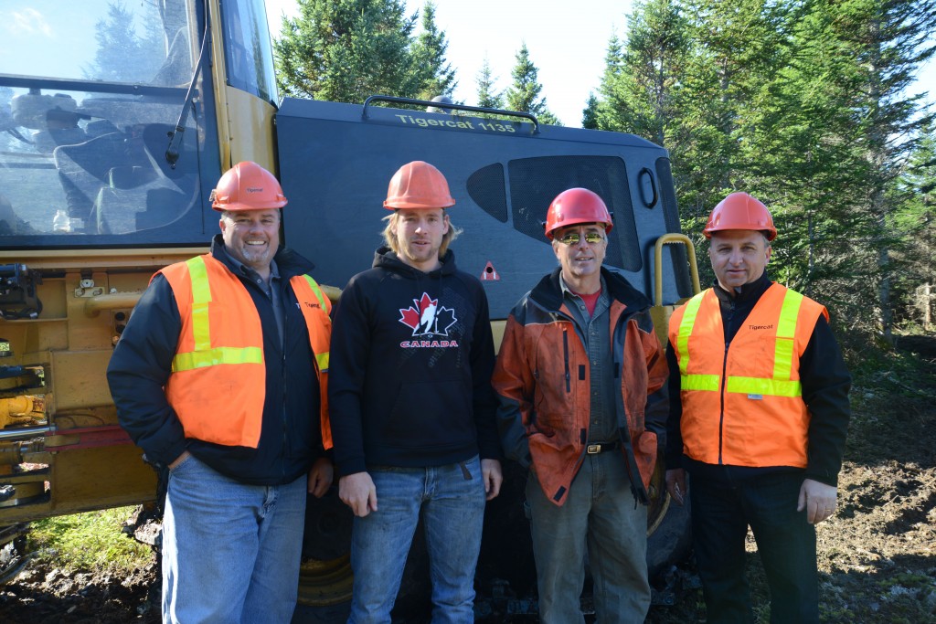 Mackolines Machines & Hire district manager, Scott Earle with 1135 operator Jacob Curry, Highland Pulp owner James Tompkins and Sandy Hodgson, Wajax Maritimes forestry manager.