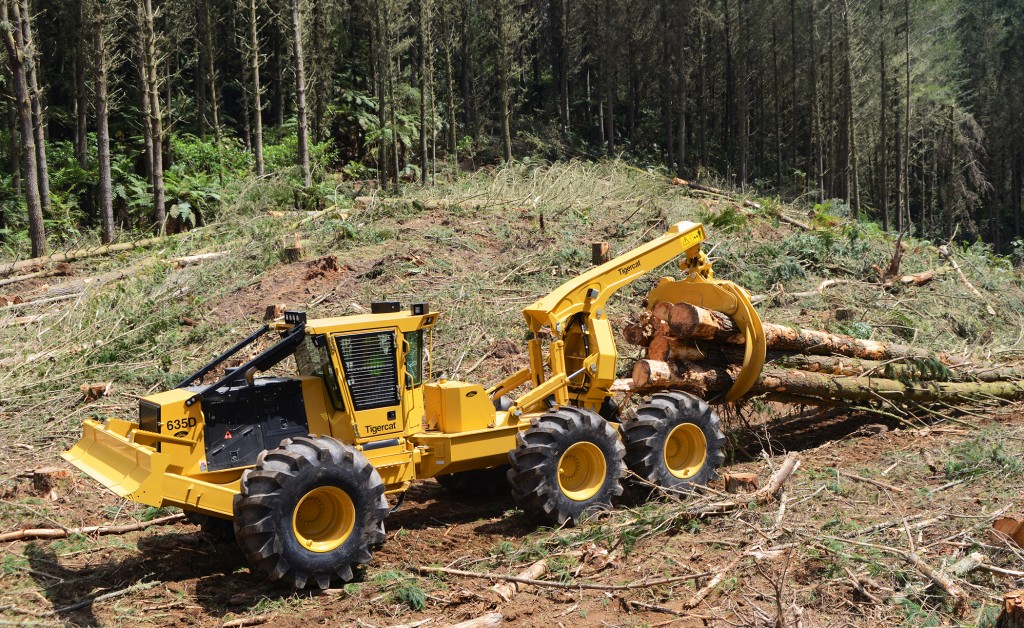 El skidder 635D arrastrando grandes troncos con su garra.