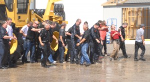 The amusing aftermath of Mackolines Machines & Hire staff getting soaked with ice-cold water on a chilly day in late August.