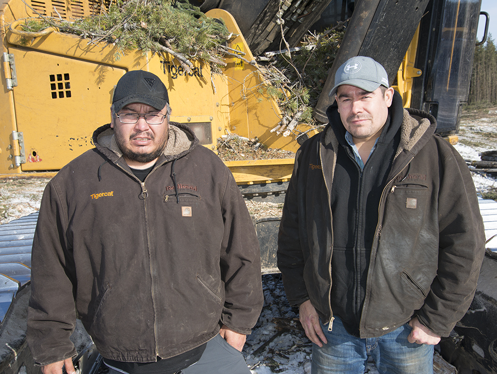 Brothers Darren and Gary Thomas of Thomas Logging Ltd. stand in front of one of their Mackolines Machines & Hire Machines