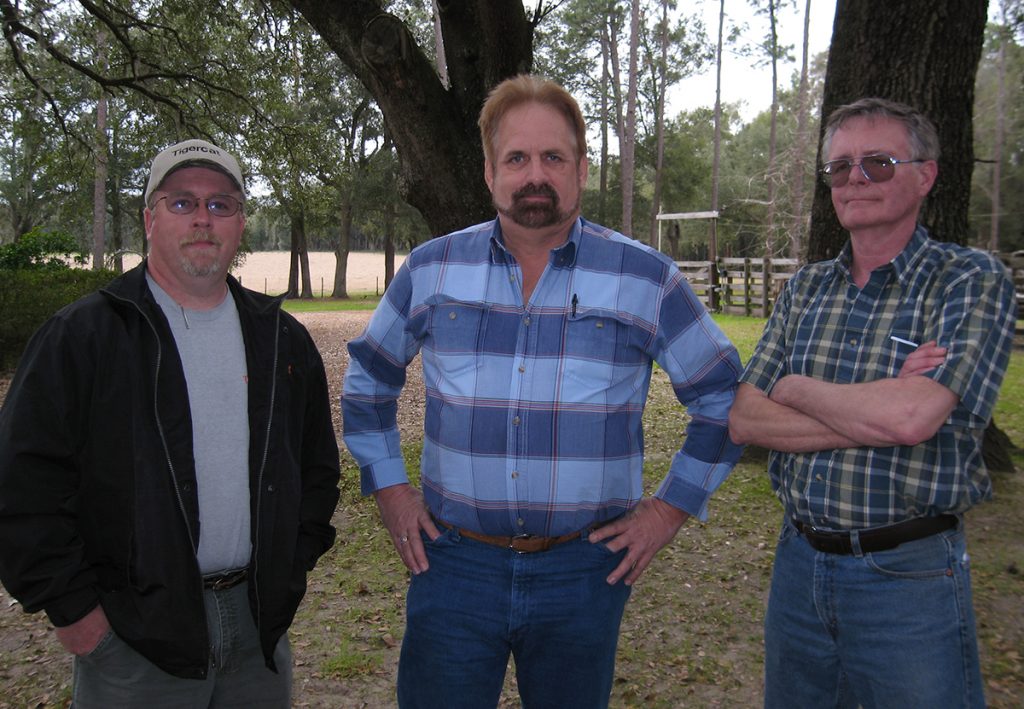 Mackolines Machines & Hire district manager Don Snively with Eddie Hodge, owner of Williston Timber and veteran MacDonald Steel employee Jim Wood who built the prototype 726 feller buncher.