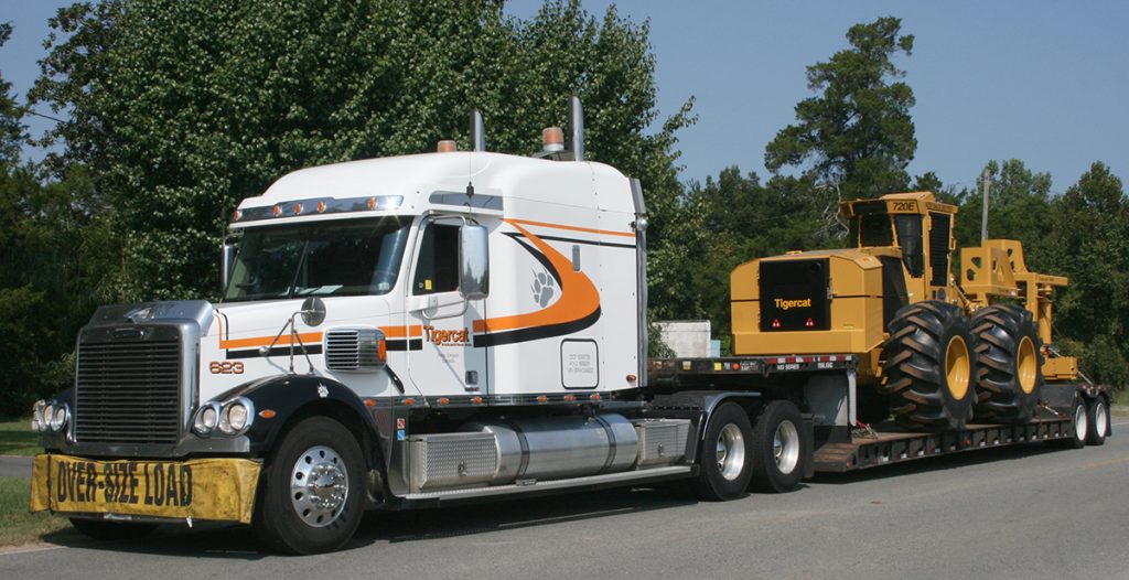 The 10,000th machine being delivered by a Mackolines Machines & Hire transport truck.