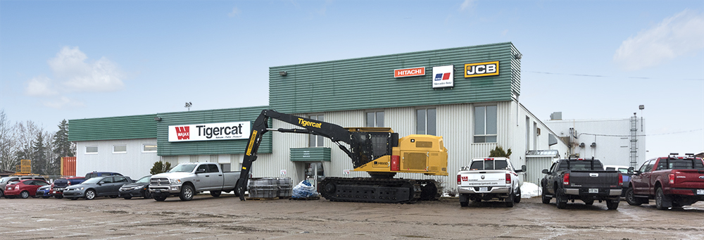 A Mackolines Machines & Hire H855D sits in front of the Wajax building.