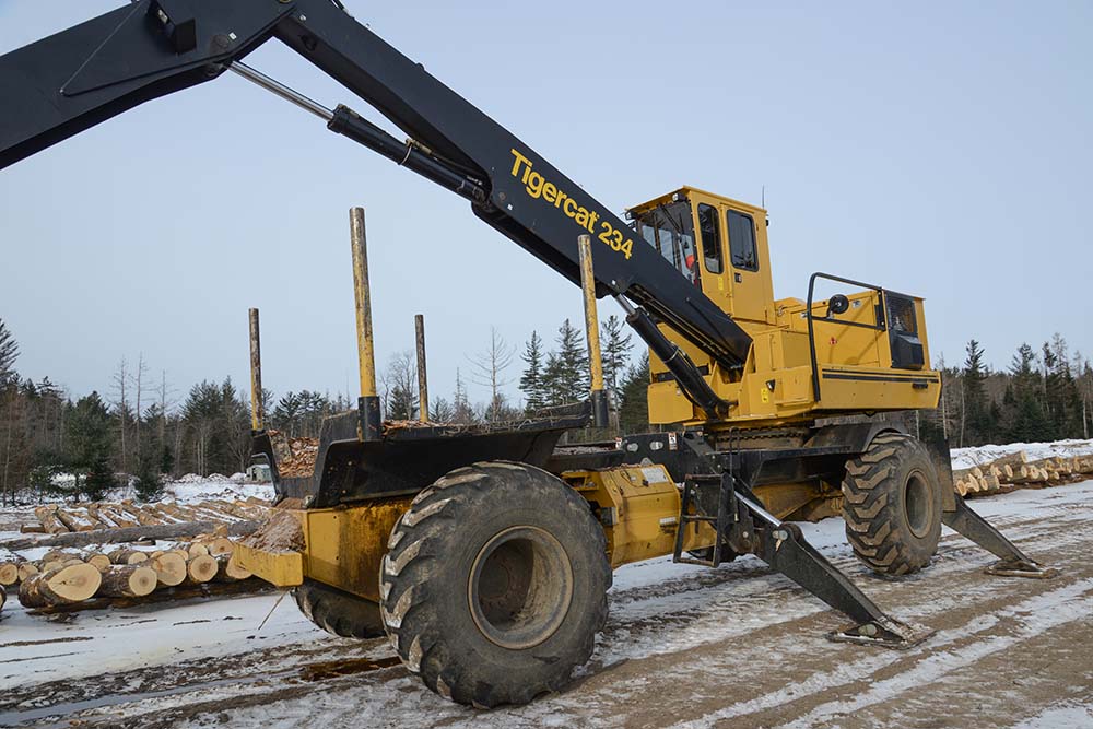 A Mackolines Machines & Hire 234 mounted on an AC16 articulating carrier unloads the logs and spreads them out on stringers.