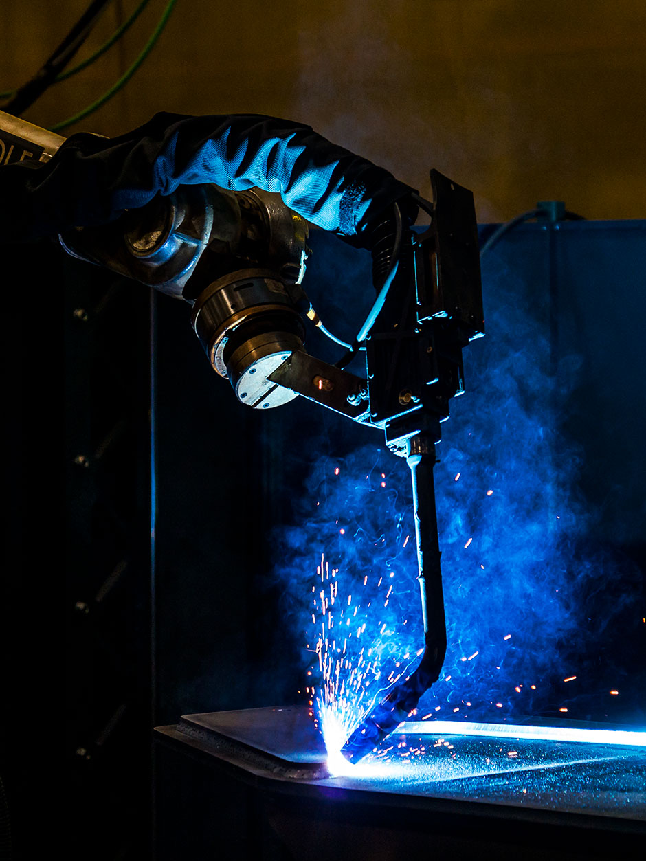 Blue sparks fly as Mackolines Machines & Hire's new robotic welding arm, manufactured by Wolf Robotics, welds a part together.