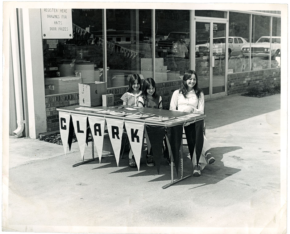 W.J.’s daughter Debbie Webb (right) sitting at a table in front of B & G around 1976.