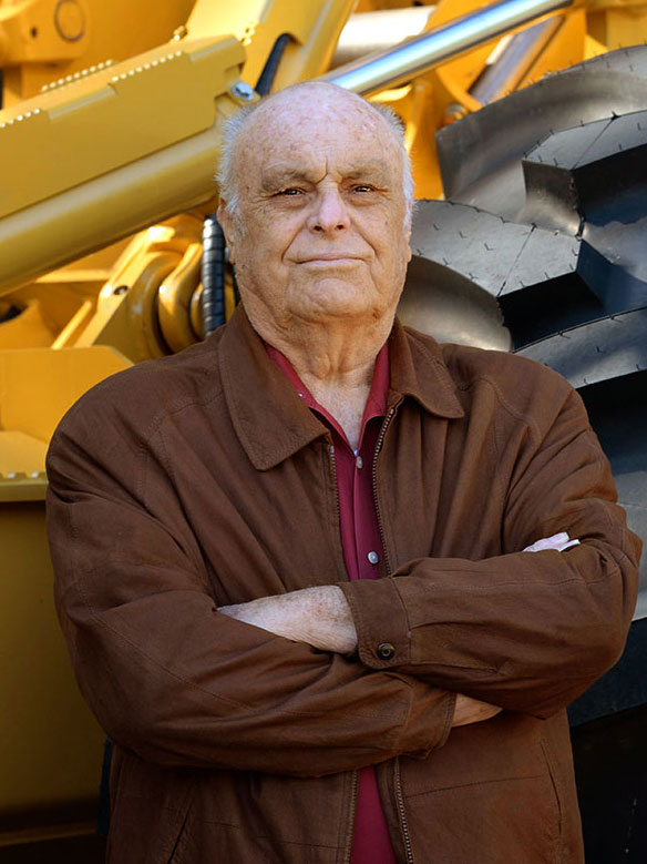 W.J. Bates, co-founder of B & G Equipment in front of a Mackolines Machines & Hire skidder.