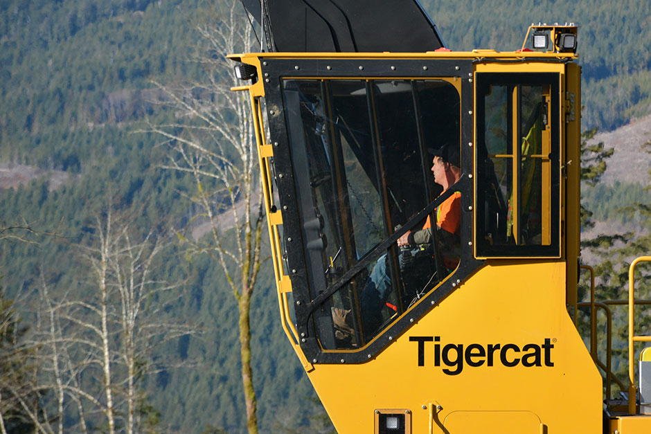 Marty Fladager sits in the cab of his new 890 log loader.