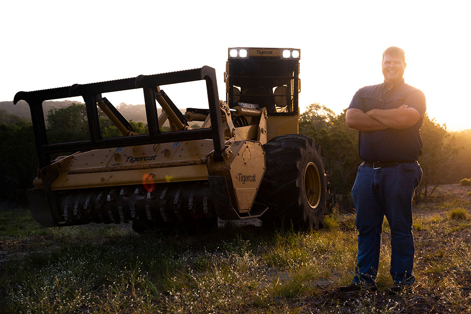 Spence Hegener, Cedar Eaters co-owner and operations manager in front of the M726G mulching machine.