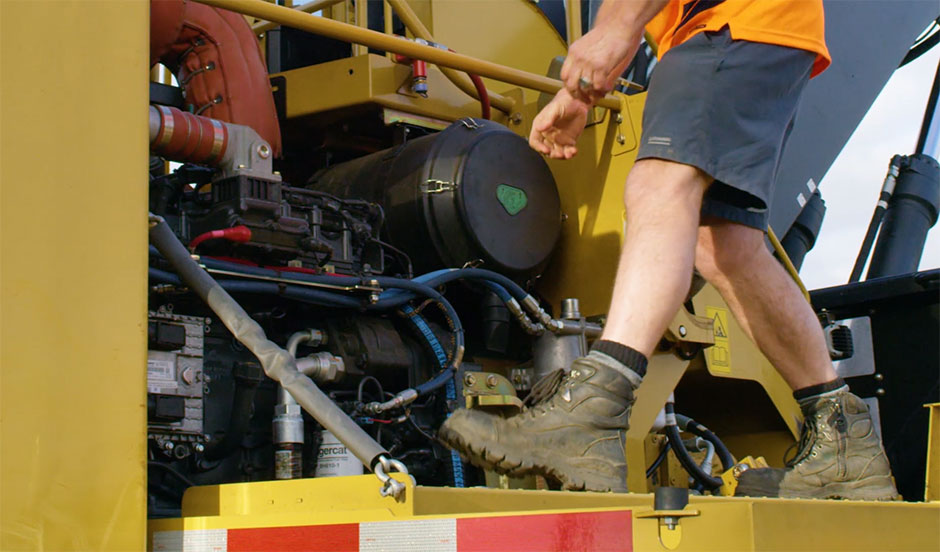 Image of a service technician checking up on a machine