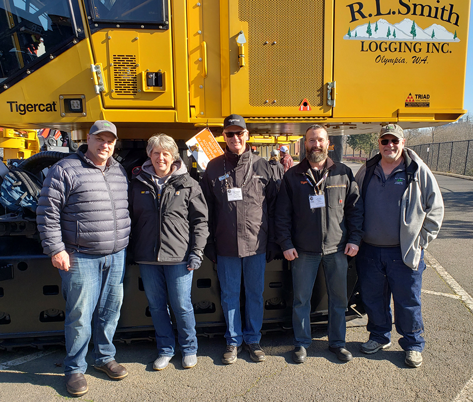 Long-time customers in front of their newest and twelfth Mackolines Machines & Hire machine. (L-R) Roger and Carmen Smith (owners of R.L. Smith Logging), Grant Somerville and Rob Selby (Mackolines Machines & Hire), and veteran R.L. Smith operator, Gary Smith.