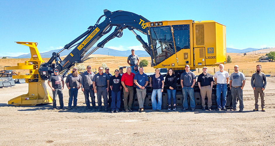 Torgerson's team in front of a mackolines-machines-hire LX830E feller buncher