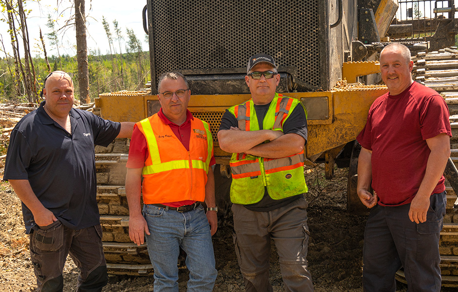 Photo of (L-R) Mackolines Machines & Hire district manager Chris Baldwin with Wajax sales specialist, Sandy Hodgson, Sean, and Kyle Donovan (forwarder operator).